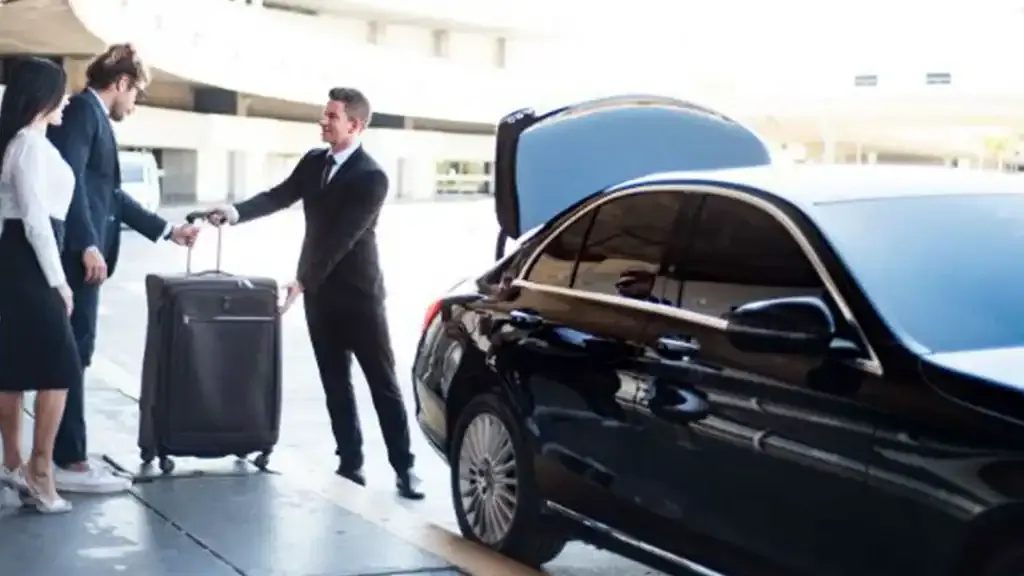 Professional shuttle drivers providing luggage assistance for passengers traveling from Houston to Galveston.