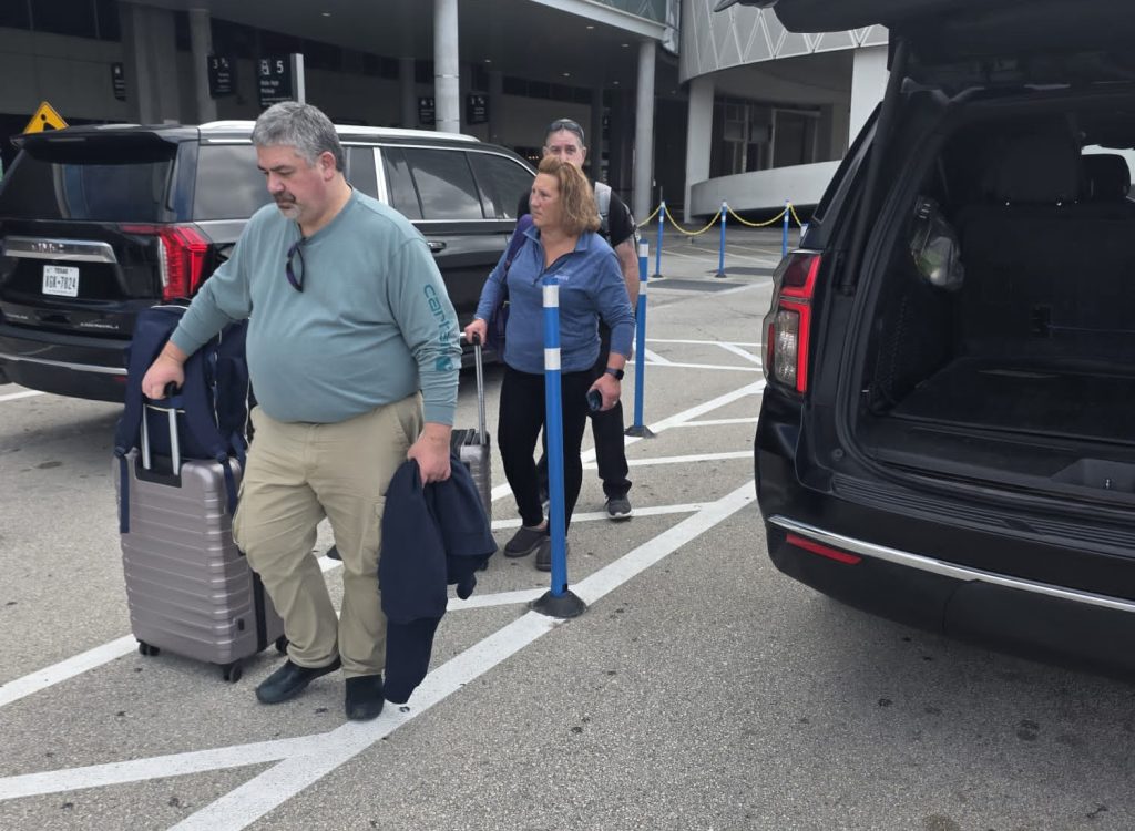 Happy customers loading luggage for Galveston to Houston shuttle transfer after cruise